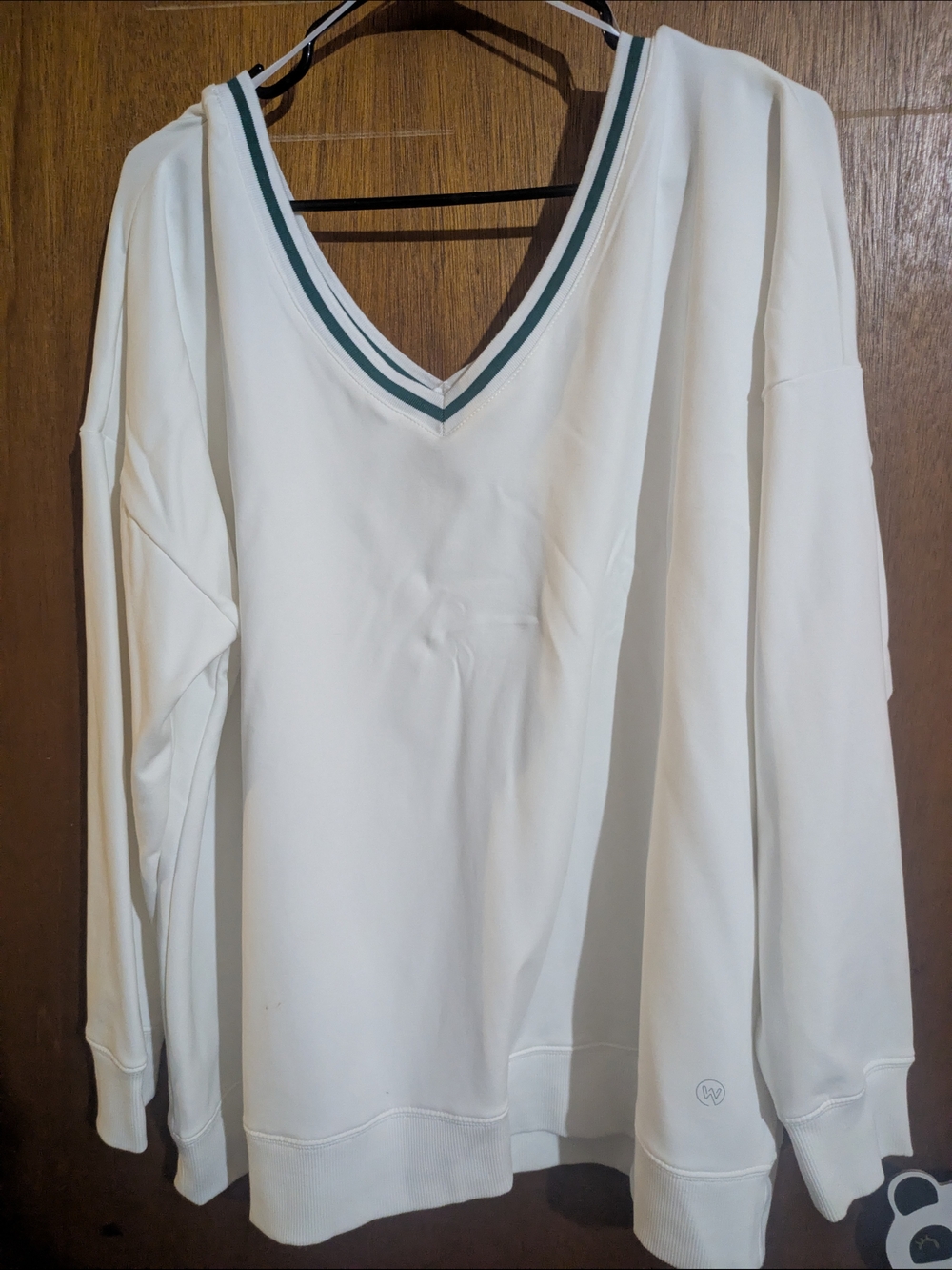 Fleece Lined White V-Neck Pullover with Green Trim.